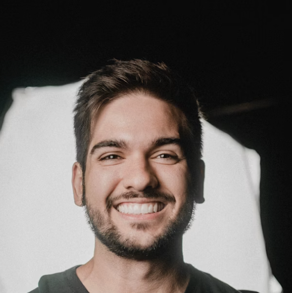 Smiling bearded man dark background